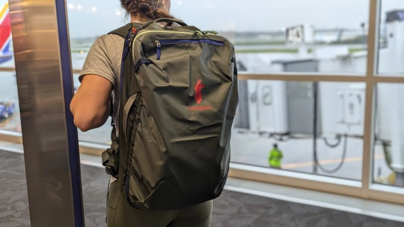 A colorful Cotopaxi Allpa 35L backpack shown in a lifestyle setting.