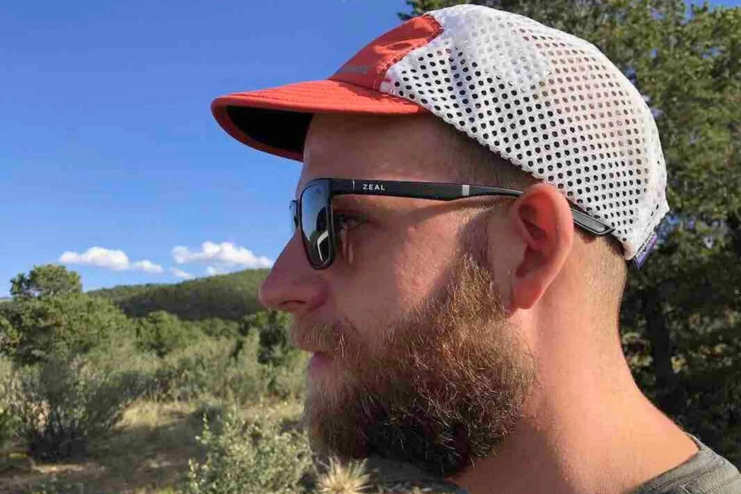 A close-up view through a mesh hat showing the sun's light passing through large holes.