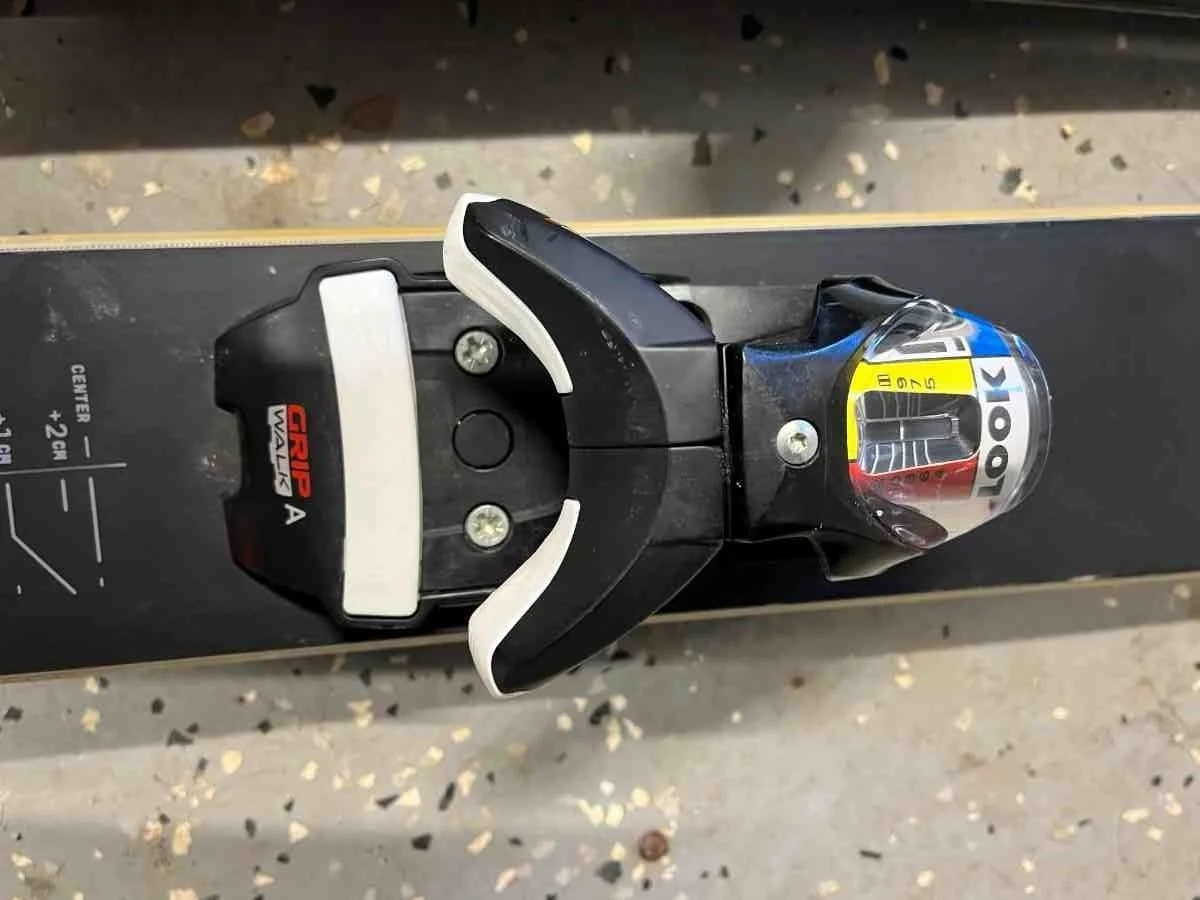 Close-up of a standard alpine ski binding toe piece showing mechanical parts.