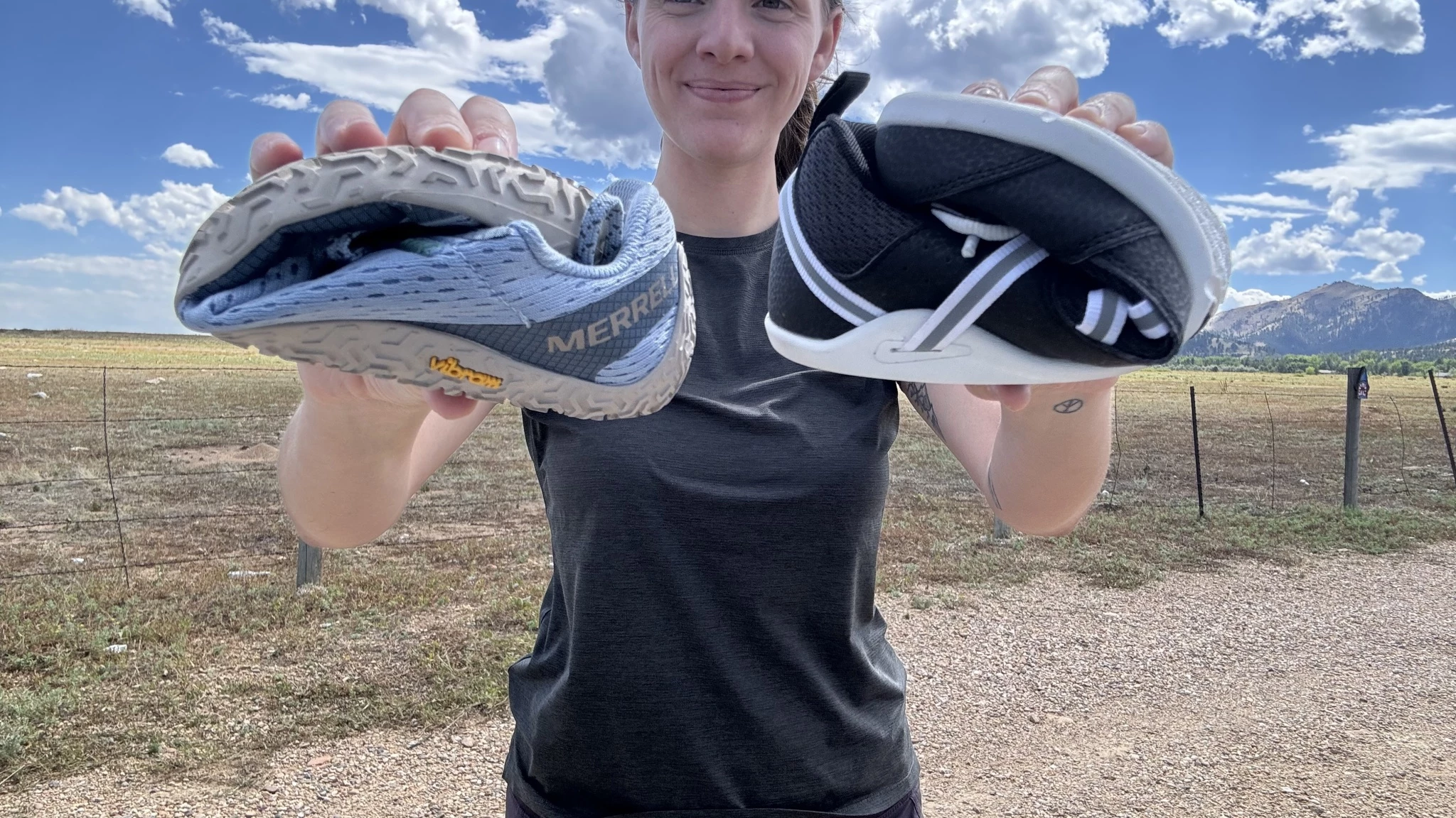 A hand rolling a Merrell Vapor Glove to show extreme flexibility.