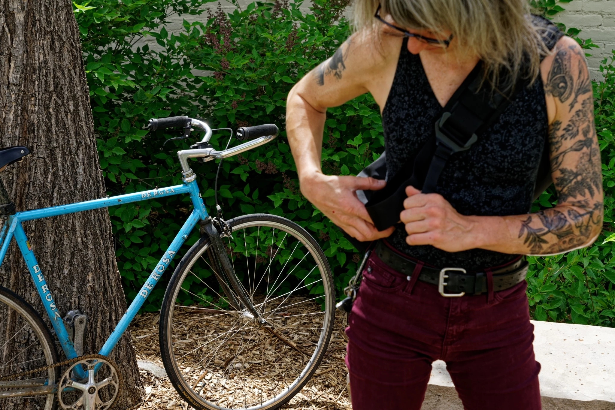 Detail shot of the adjustable shoulder strap and velcro strap minder on a messenger bag.