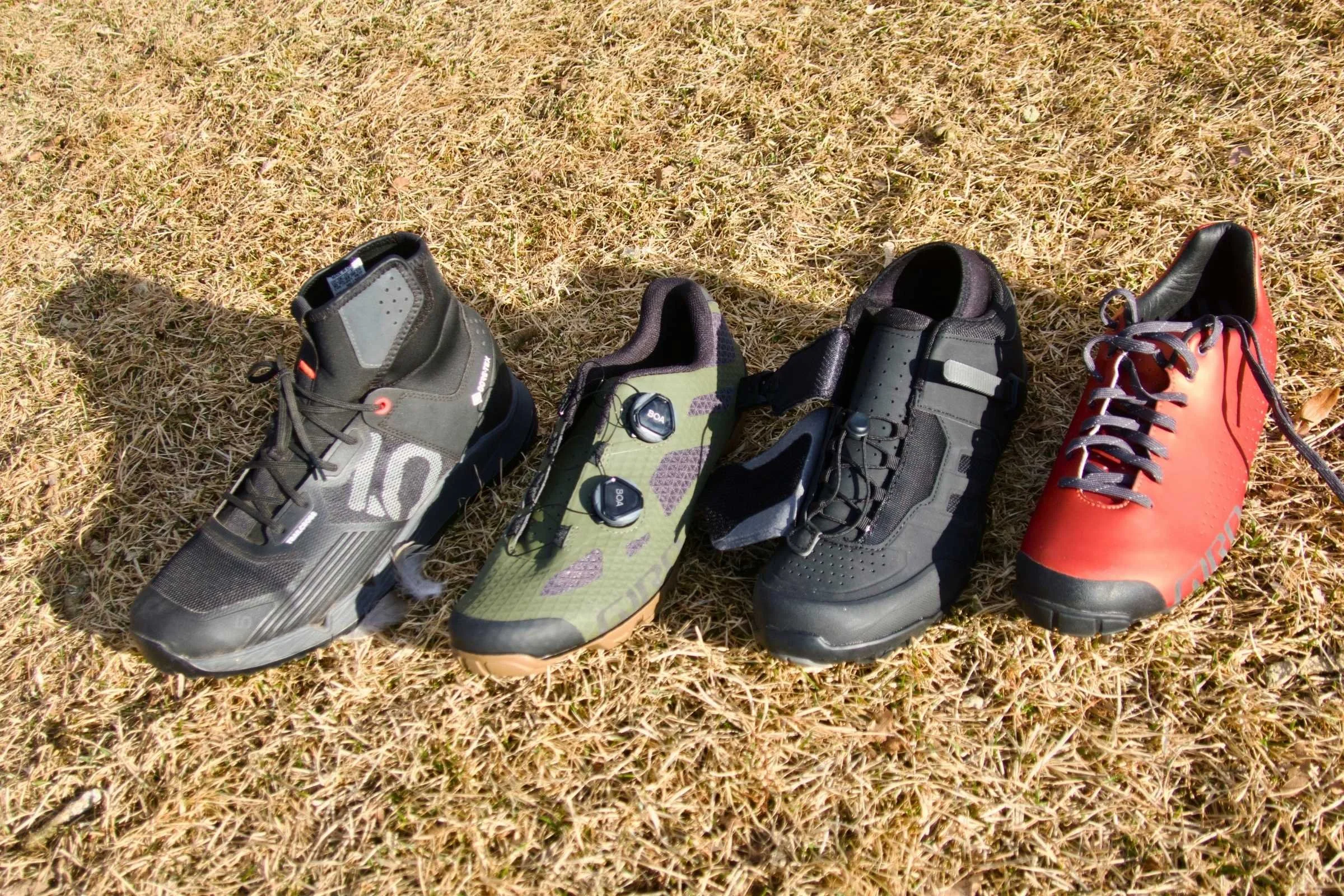 A selection of mountain bike shoes showcasing different closure systems like BOA, laces, and Velcro straps.