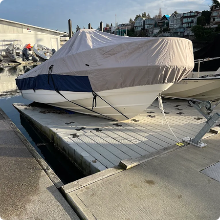 Reinforced strap and buckle system on a trailerable boat cover.