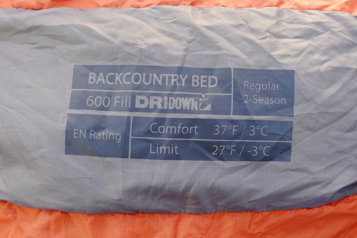 Close-up of a sleeping bag label showing the EN/ISO temperature rating scale.