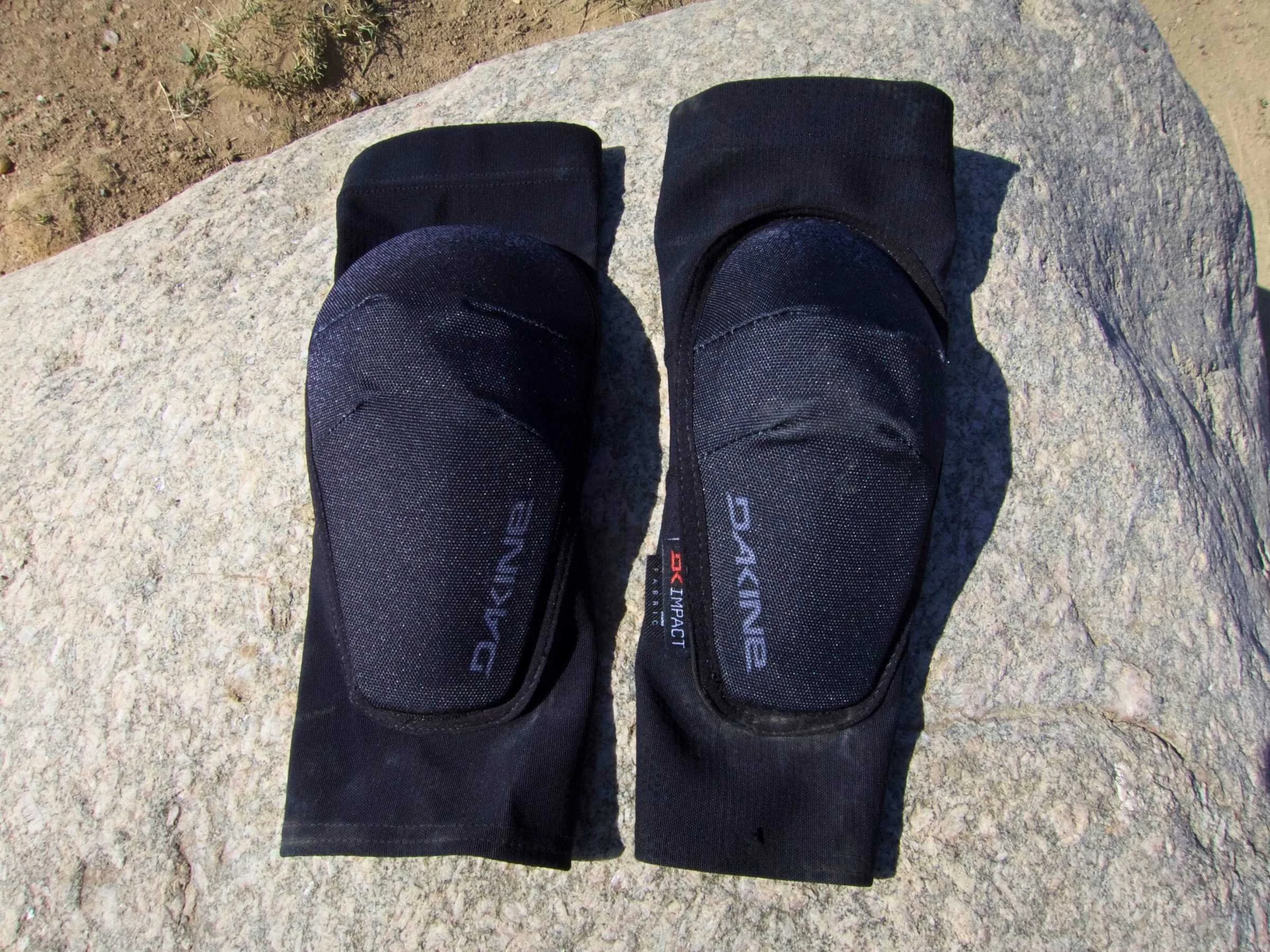 Comparison of two sizes of Dakine Slayer elbow pads showing the robust padding.