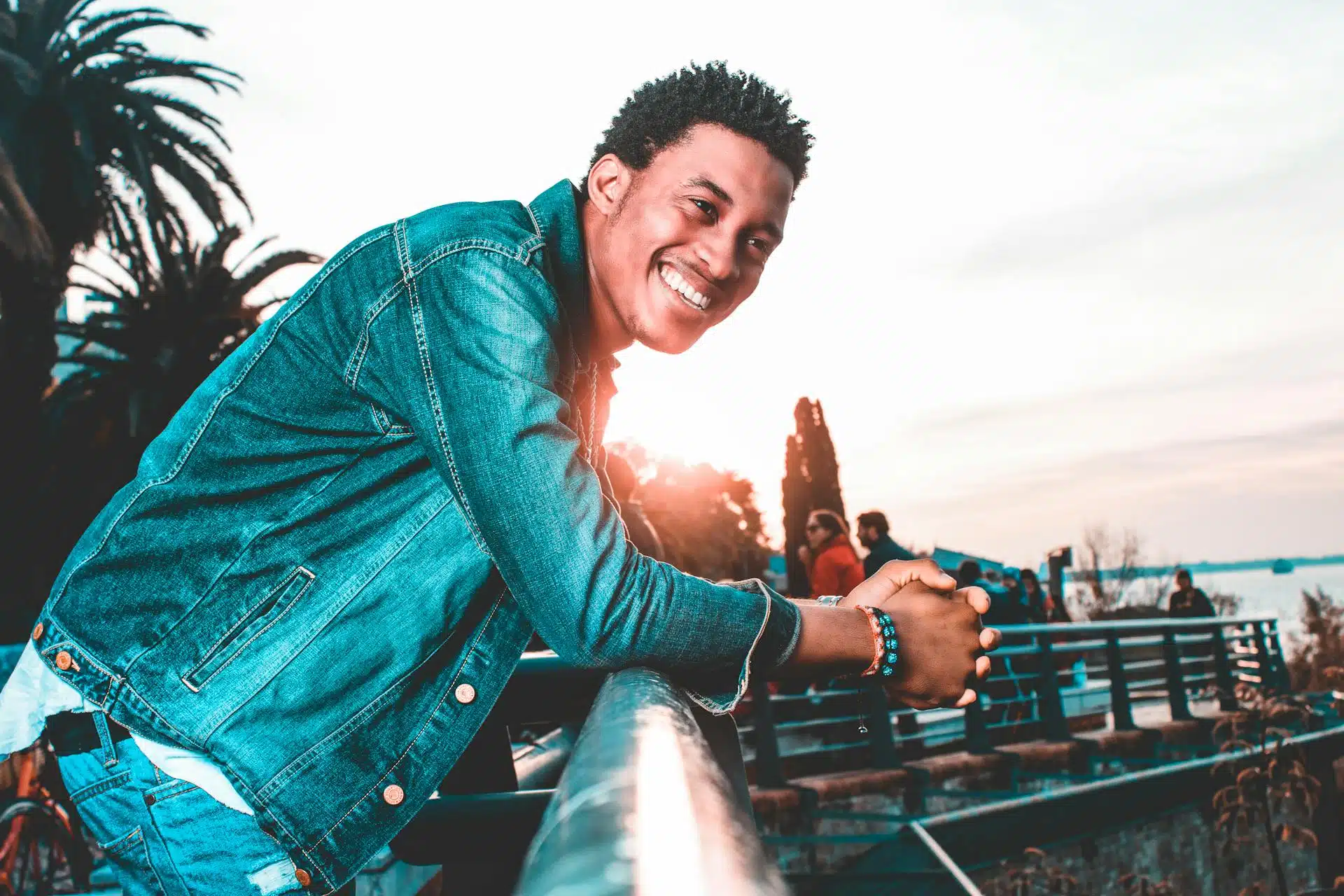 A man modeling a dark-wash denim jacket that fits his torso perfectly.