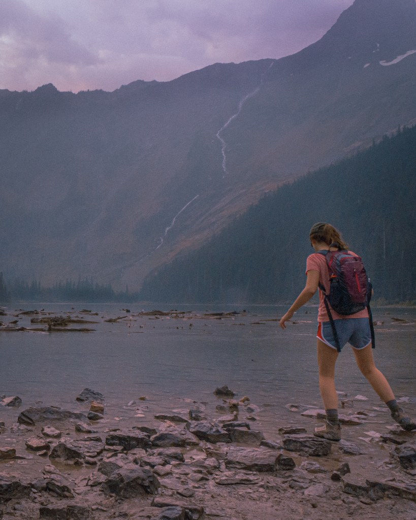A hiker wearing Merrell Moab low-rise hiking shoes while trekking through Glacier National Park.