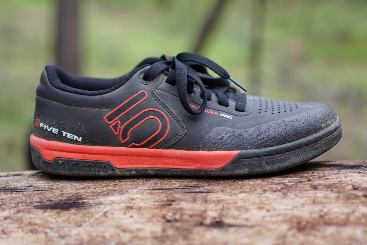 Side profile of a black and red Five Ten Freerider Pro mountain bike shoe.
