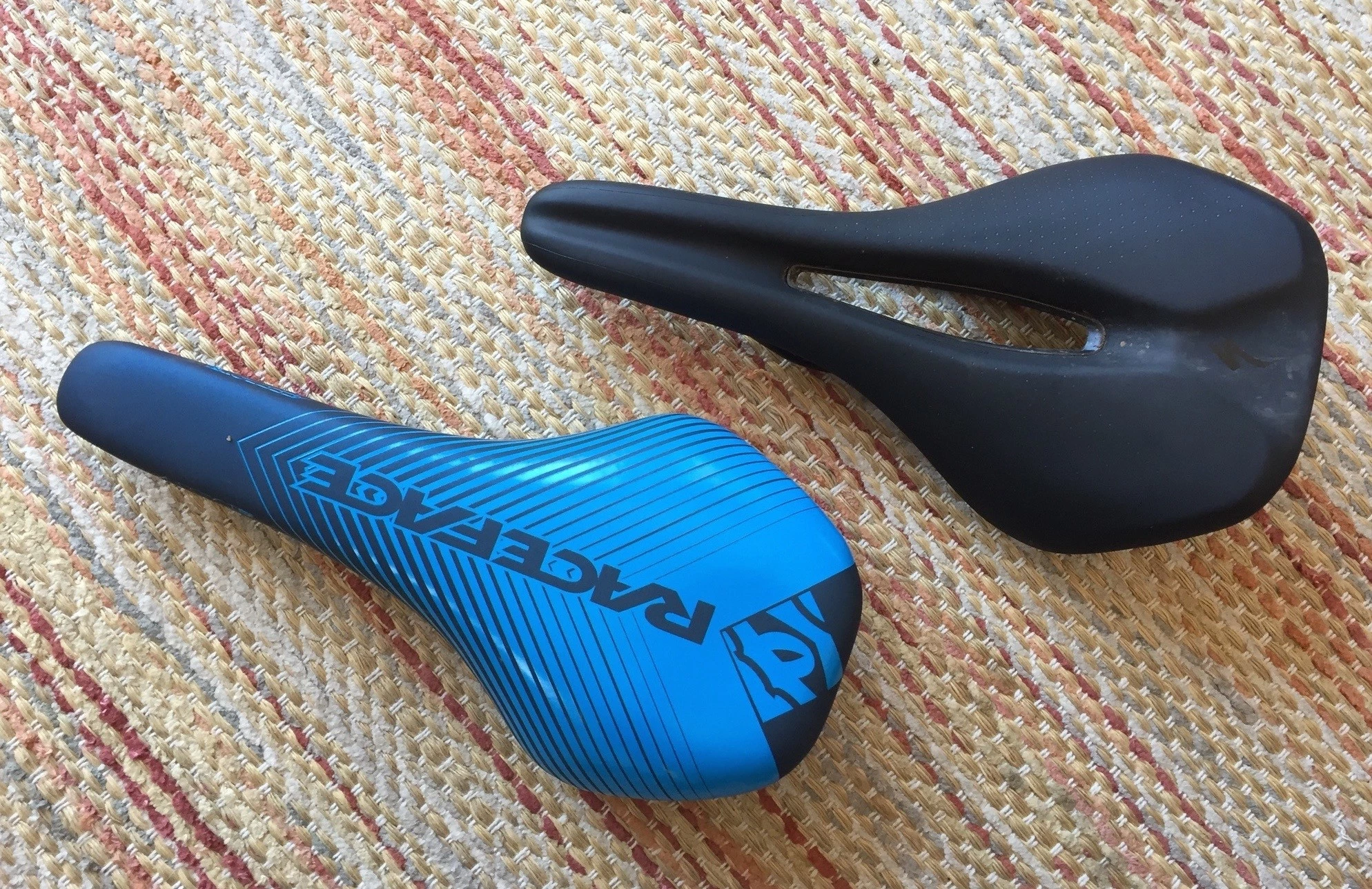 A side-by-side comparison of a wide, short-nose saddle and a traditional long, narrow saddle.