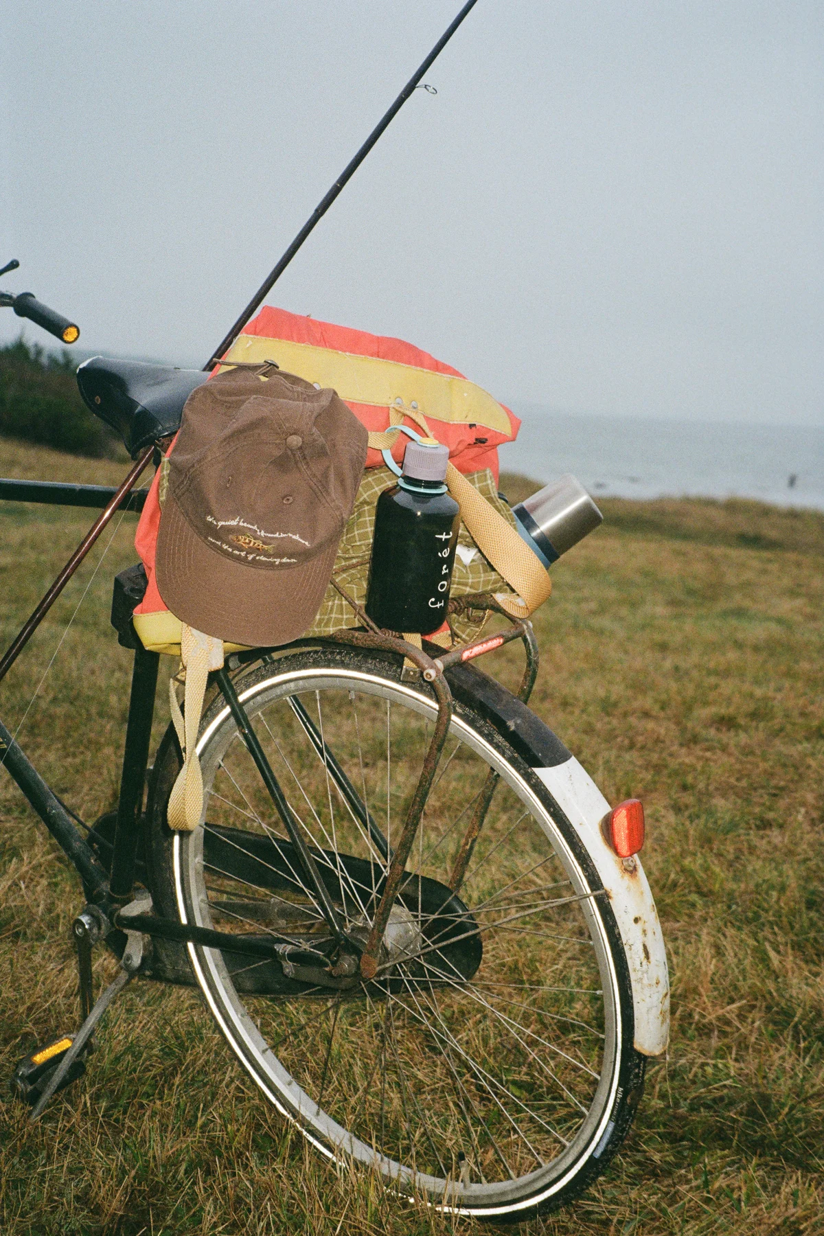 A person riding a bicycle in Forét apparel, showcasing urban utility.