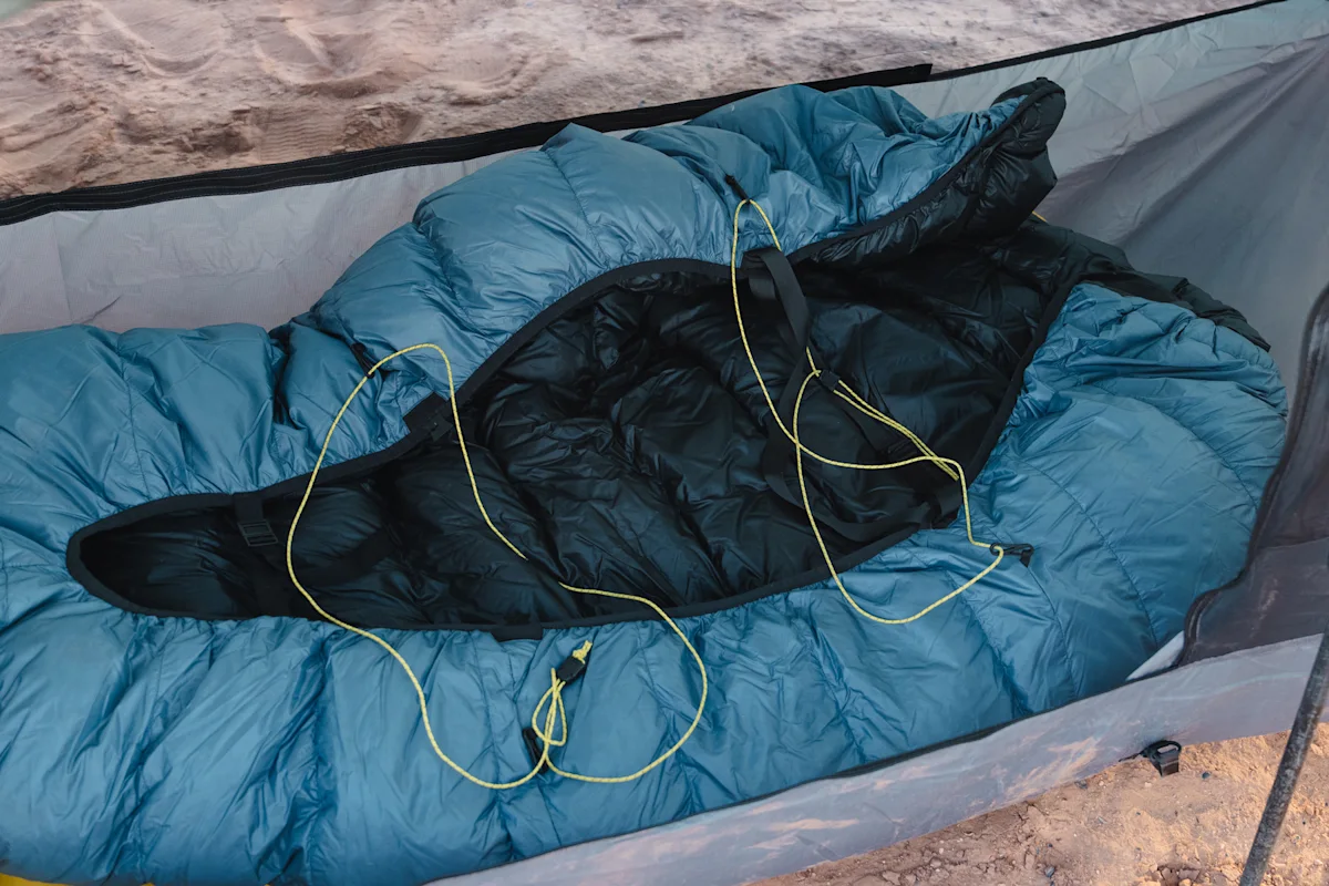 A Katabatic Gear Alsek quilt laid out on a sleeping pad inside a tent.