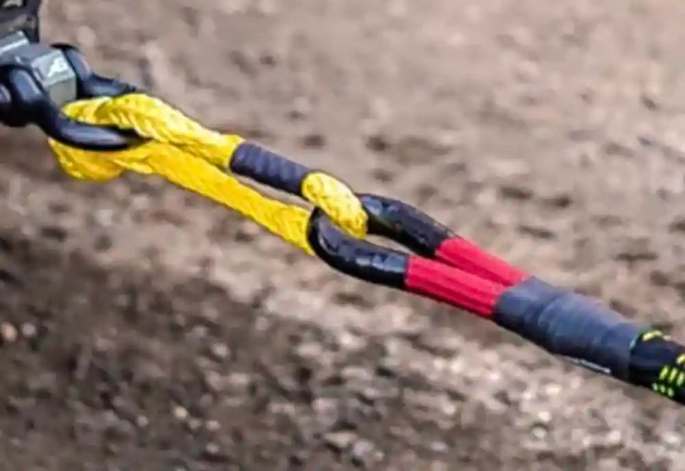 Close-up of a soft shackle and synthetic winch line connection being used for overland recovery.