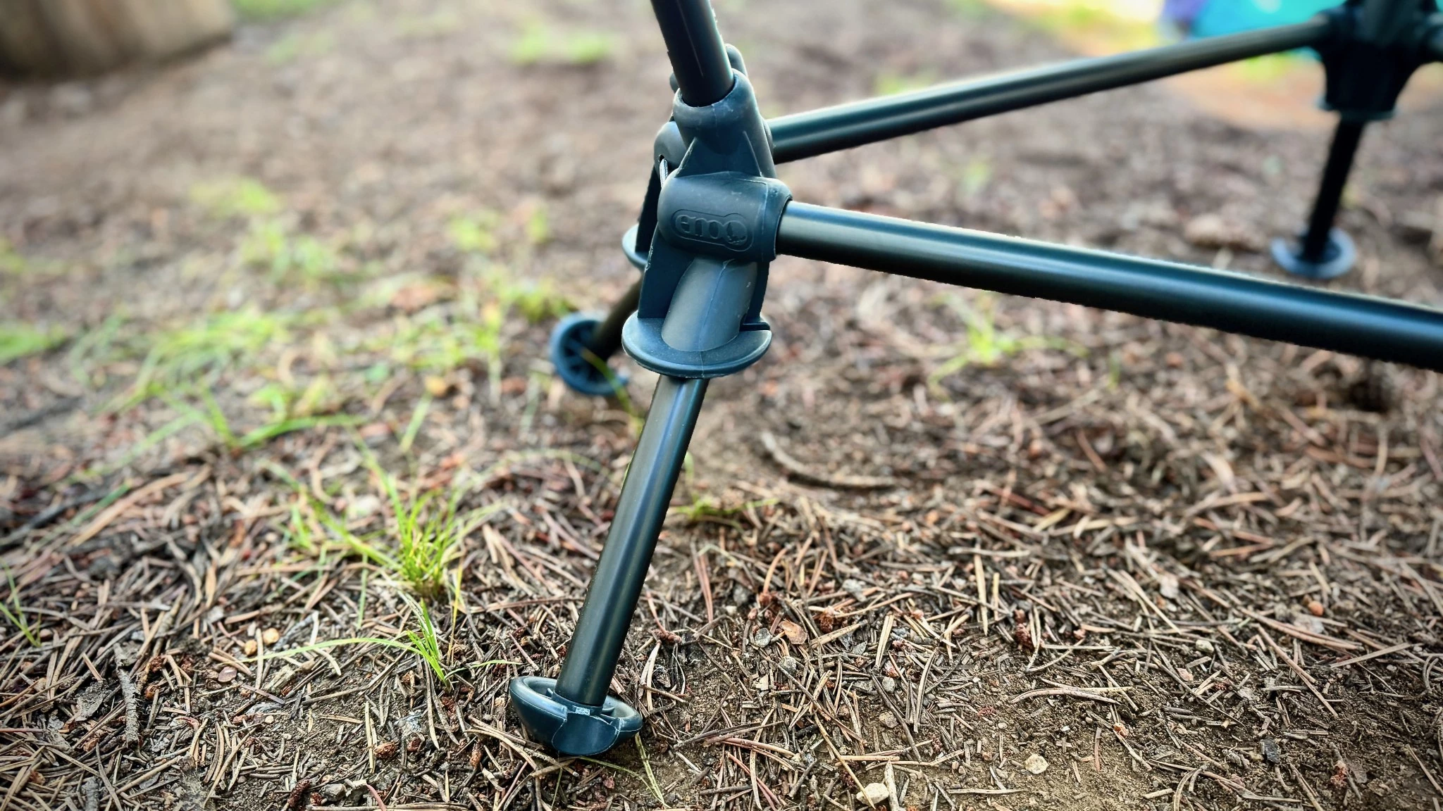 A camping chair leg with a wide saucer-like foot for stability on soft ground.