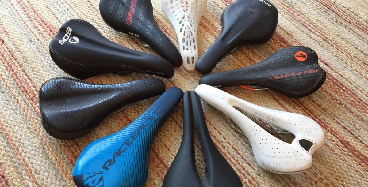An assortment of various high-performance mountain bike saddles arranged for comparison.
