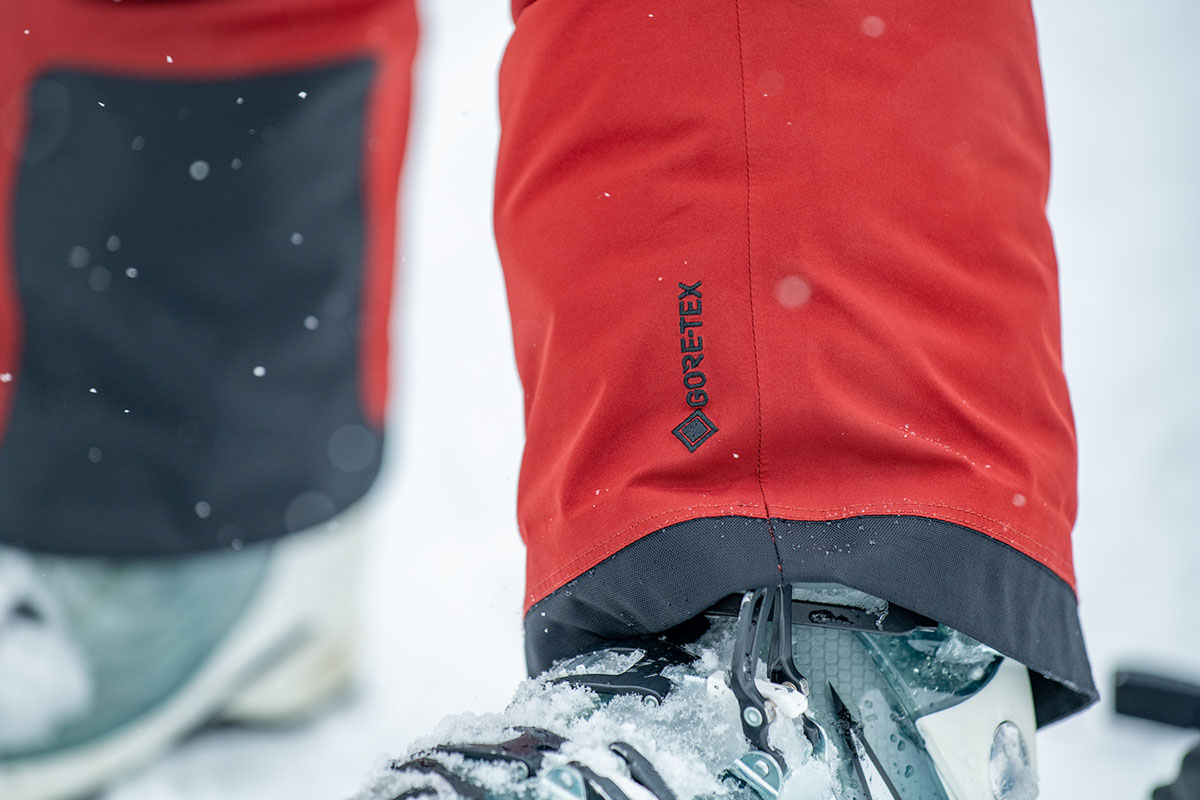 Close-up of the Gore-Tex logo on the lower leg of a red ski pant.