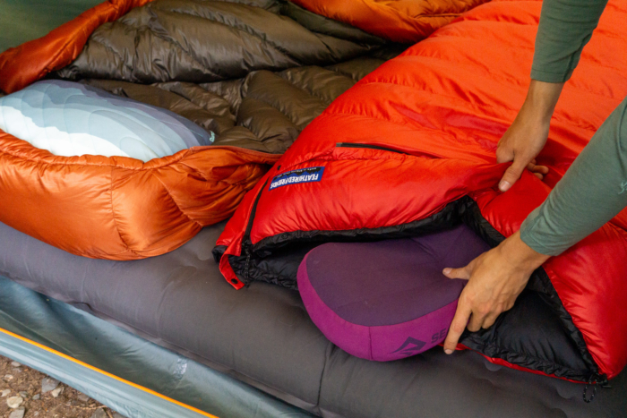 Multiple backpacking pillows laid out inside a tent for a comparative test.