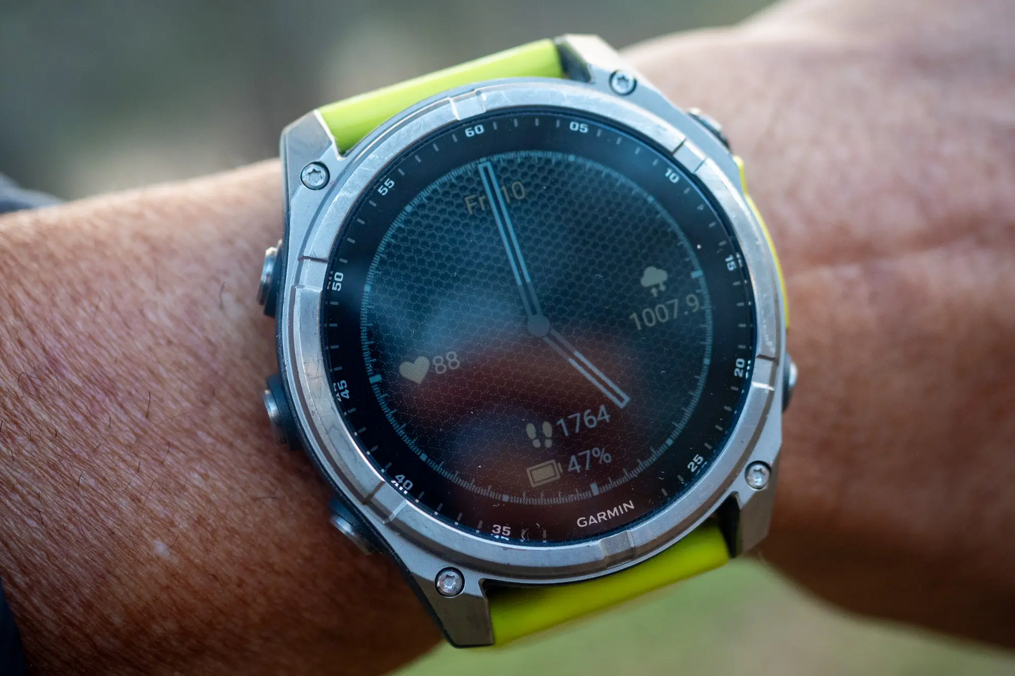 The Garmin fenix 8 Solar Sapphire edition worn on a wrist in an outdoor setting showing a training profile.