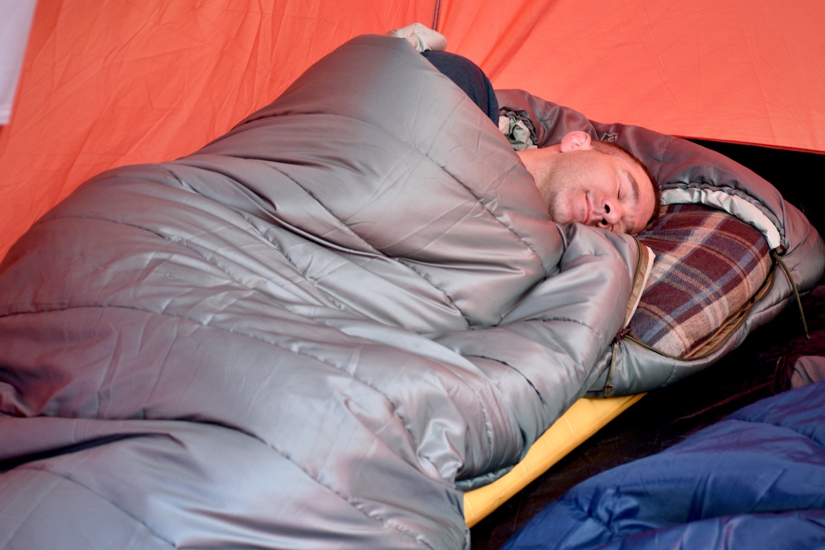 Person resting inside an REI Siesta 20 sleeping bag.