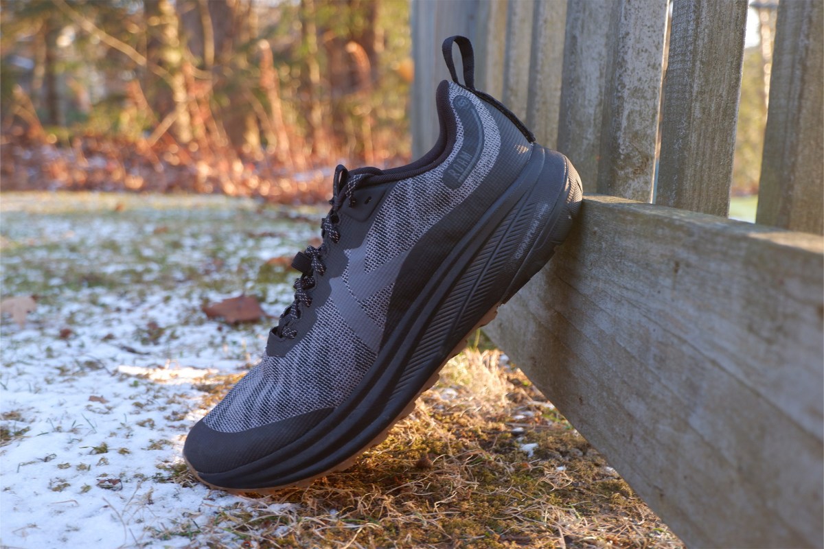 A single KEEN Roam shoe resting on a wooden fence in bright winter light.