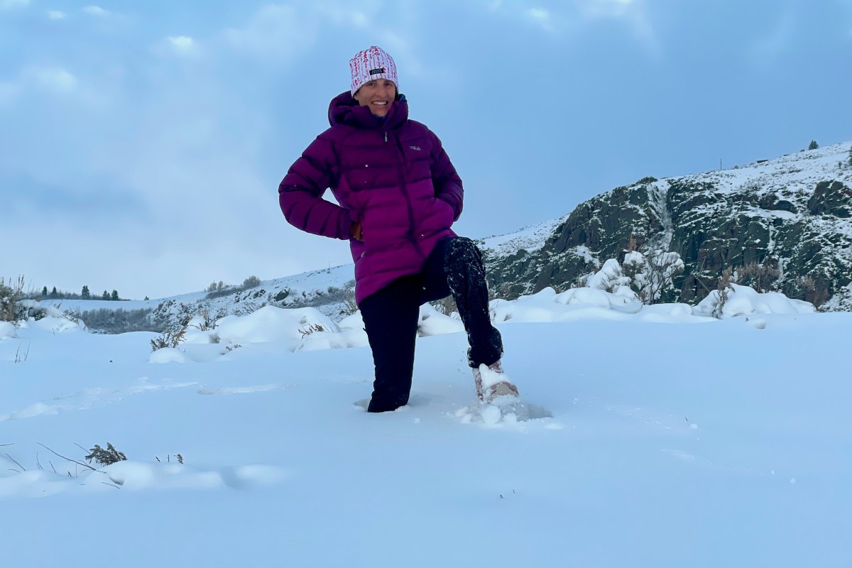 Merrell Moab Speed 2 Thermo Mid Waterproof hiking boots positioned on a snow-covered trail.