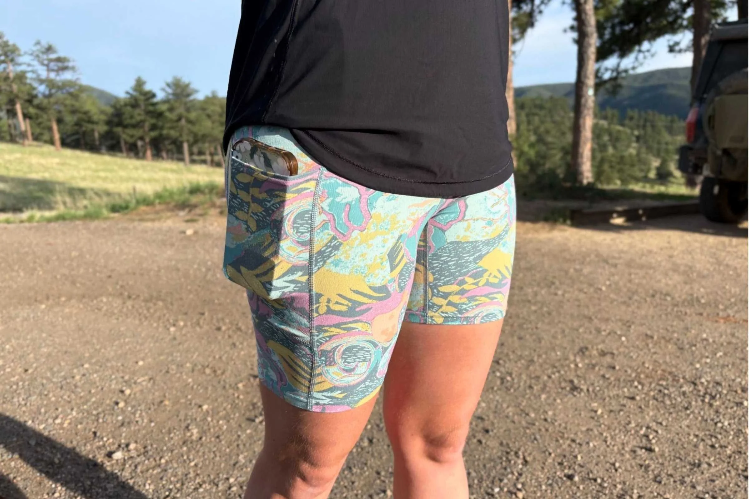Close-up of a hand accessing the side drop-in pocket on the Maipo shorts.