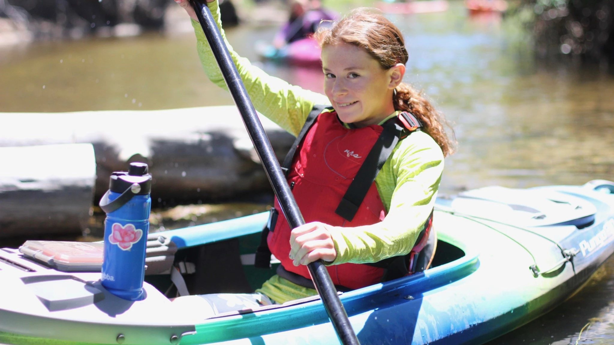 A Wilderness Systems Pungo 120 kayak on the water.