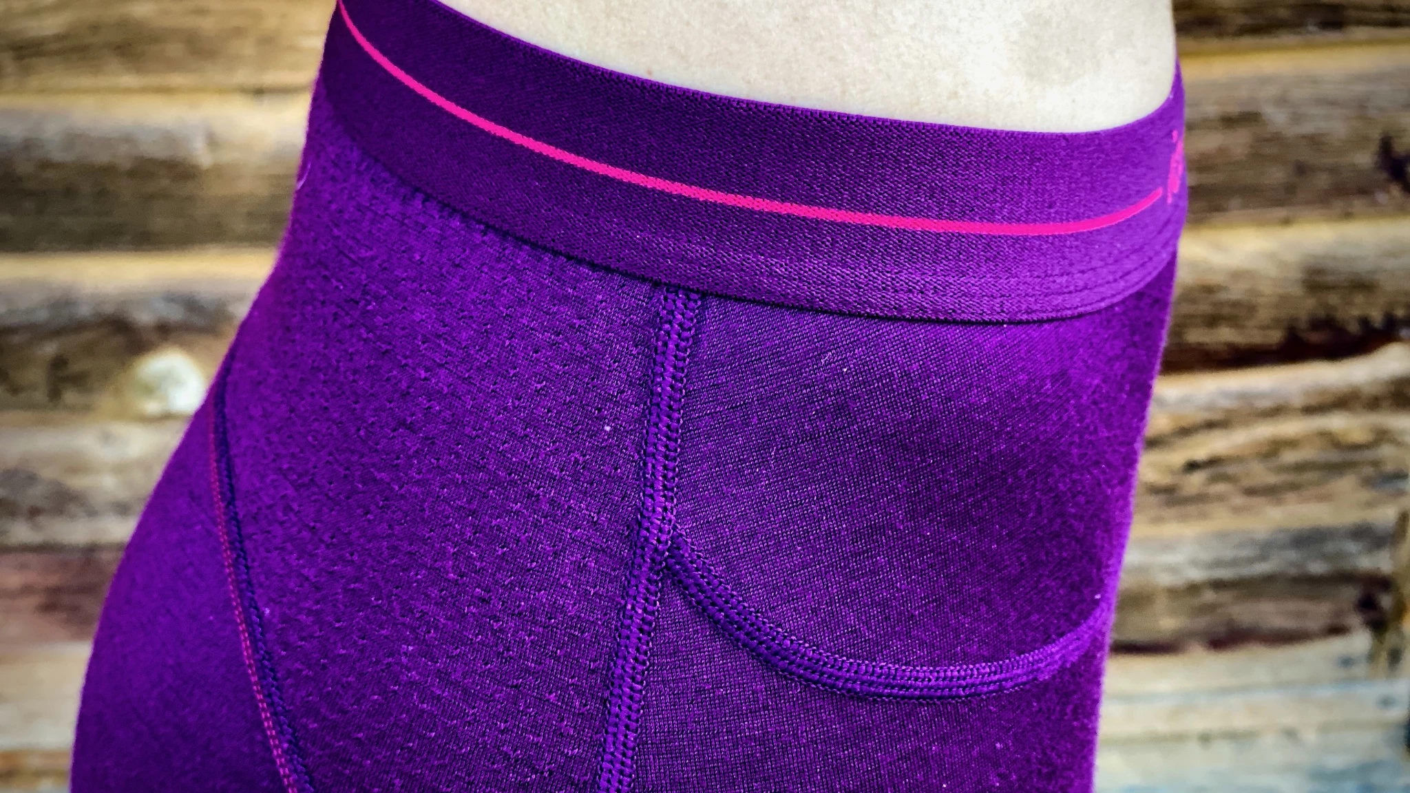 Close-up of Icebreaker 200 ZoneKnit leggings showing perforated ventilation panels and merino wool texture.
