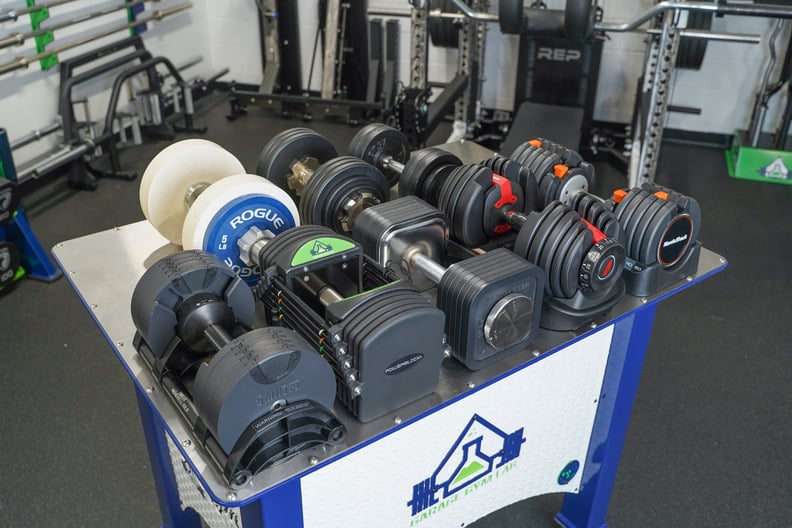 A selectorized adjustable dumbbell showing its compact design in a home gym.