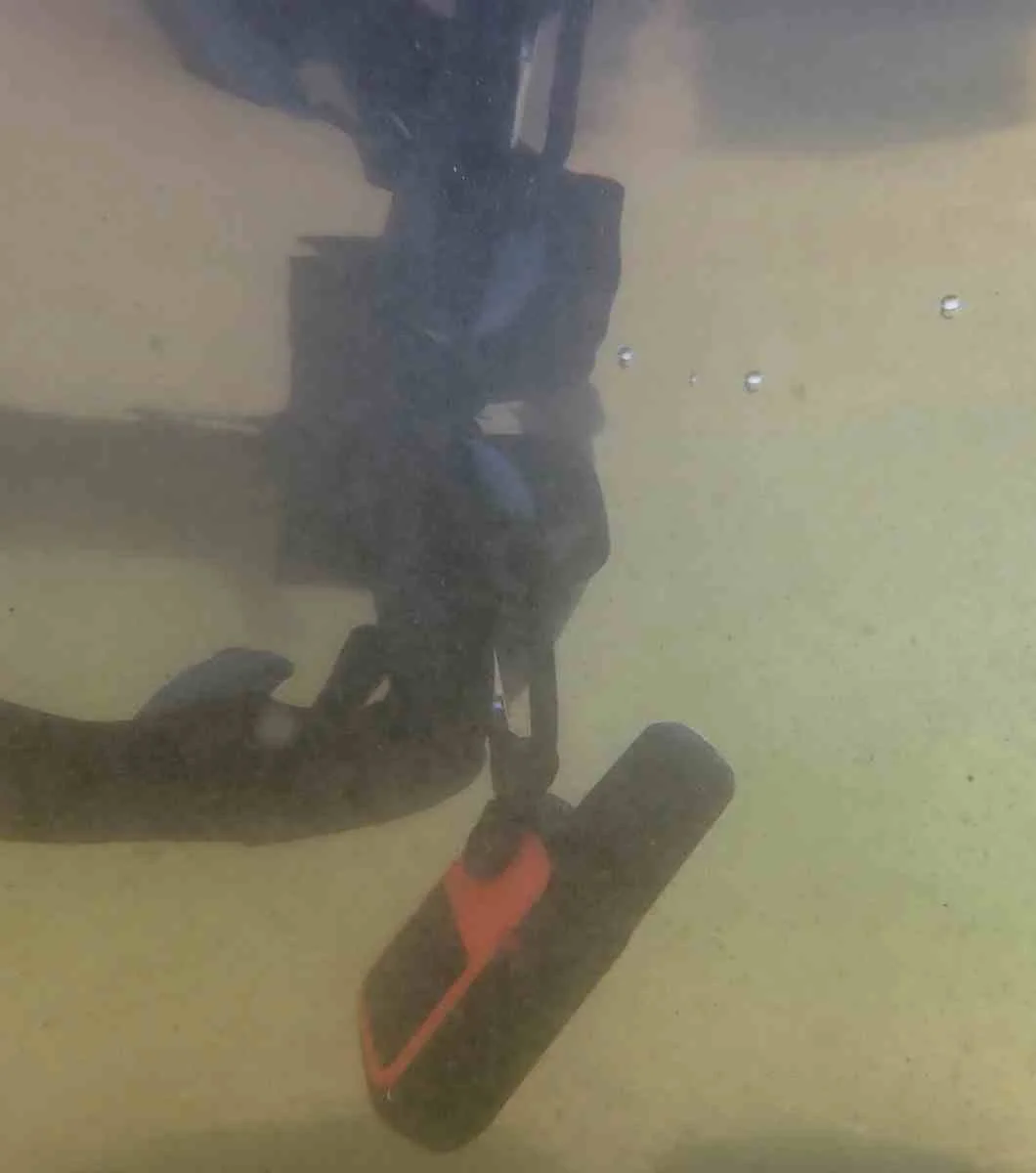 Garmin inReach Mini 2 partially submerged in water to test its waterproof capabilities.