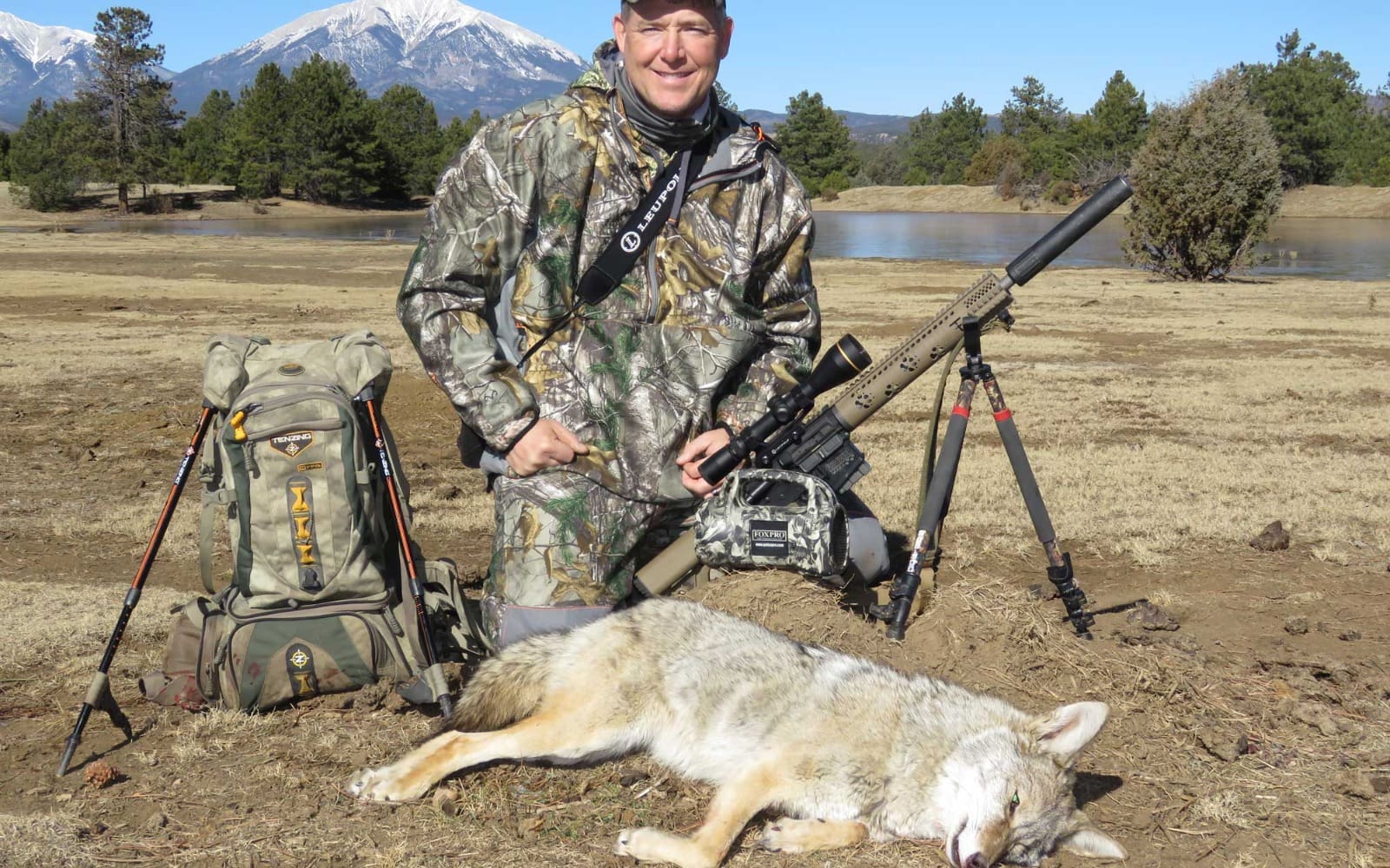 An electronic game call set up in a field at a distance from the hunter's perspective.