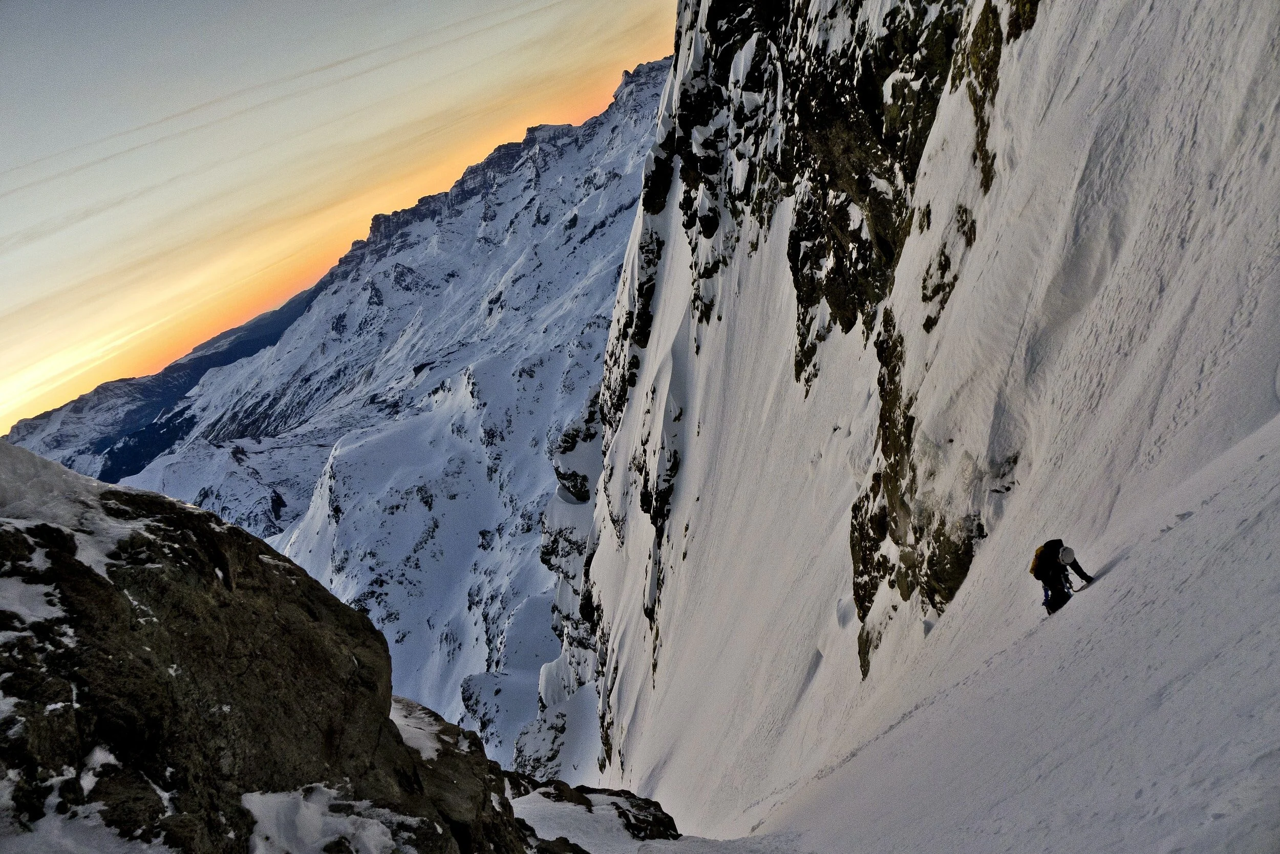 An overhead flat-lay of essential alpine climbing gear including ropes, hardware, and insulation.