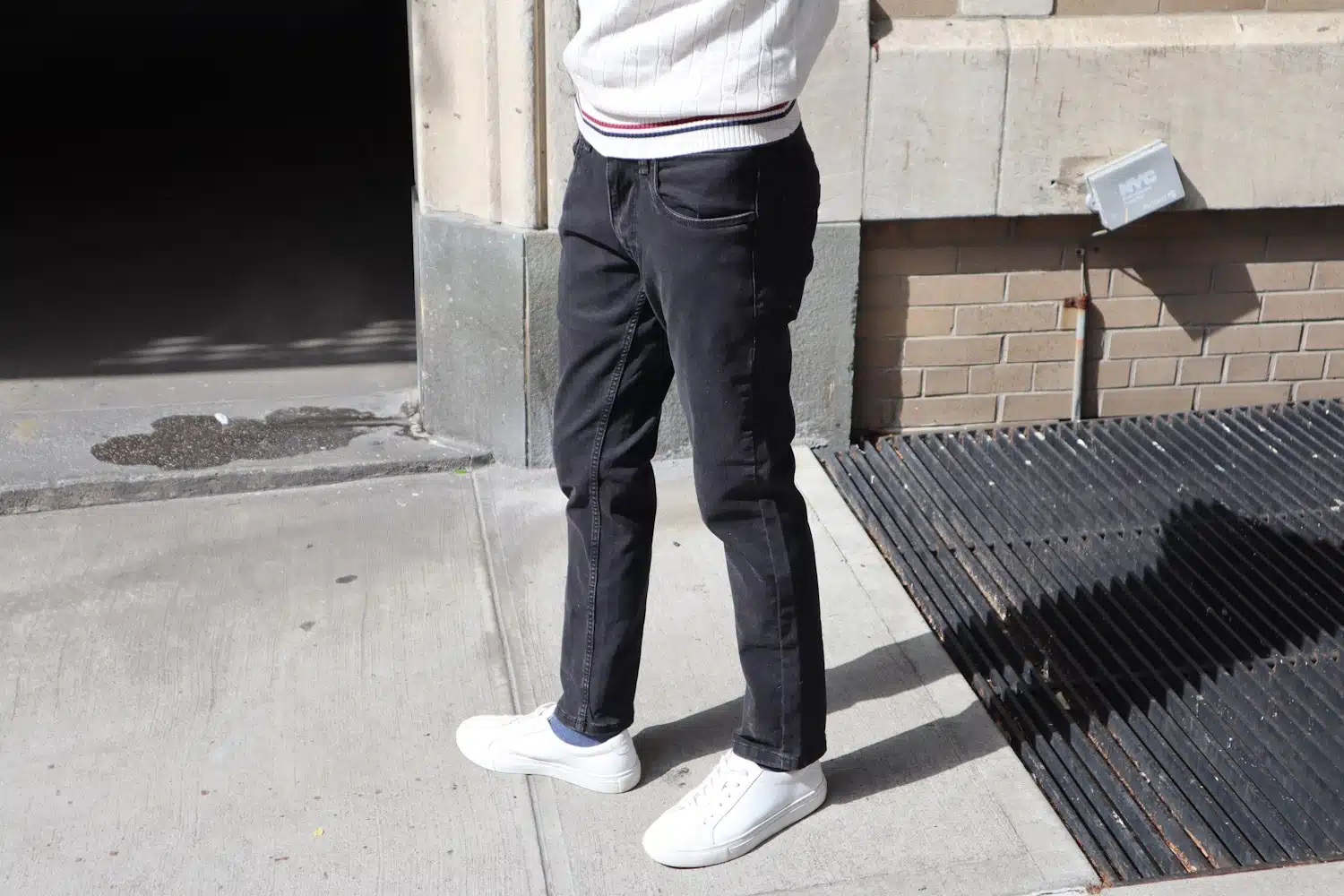 Full view of blue denim jeans laid out on a flat surface.
