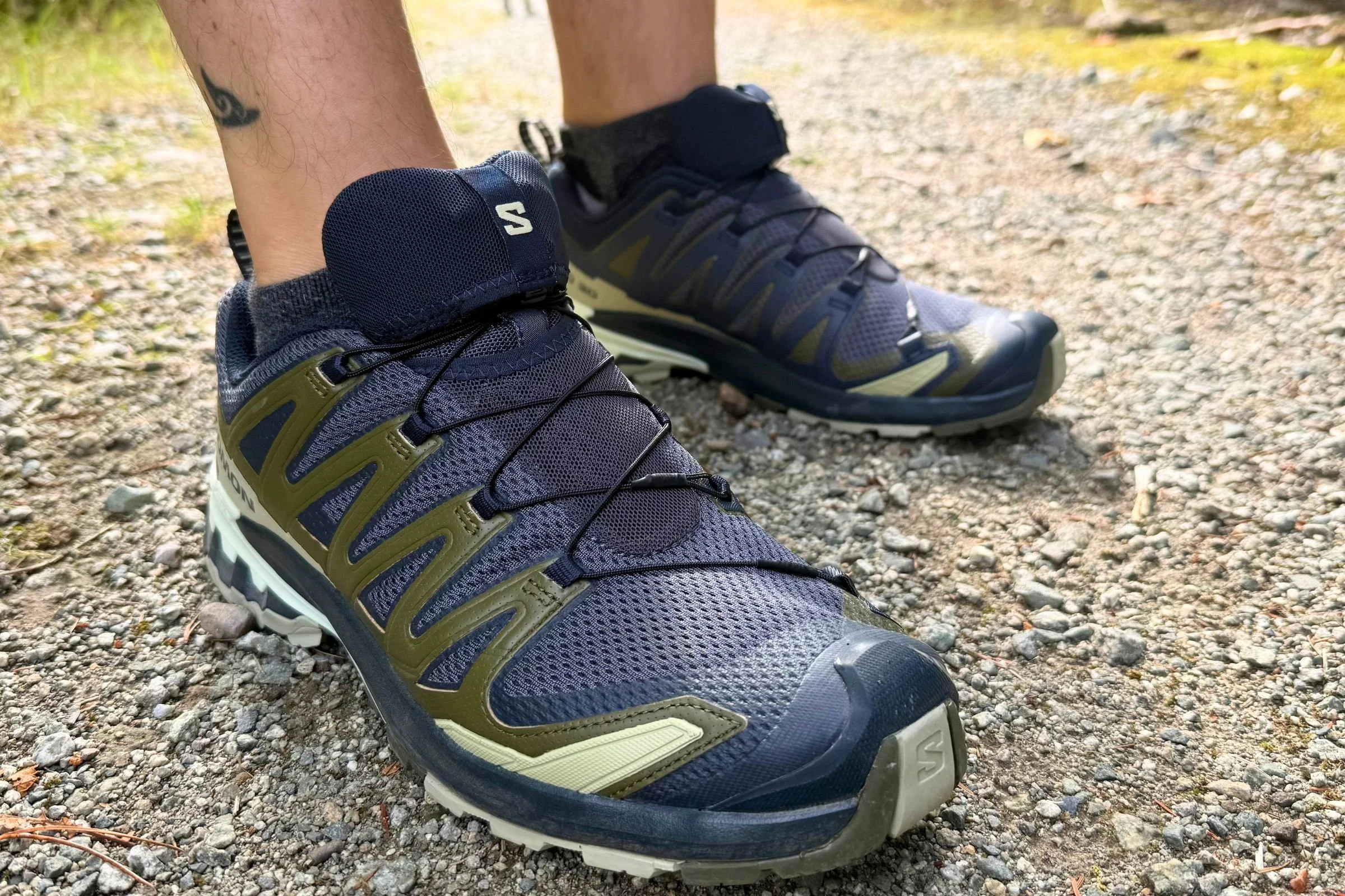 A lightweight hiking shoe moving quickly across a rocky mountain path.