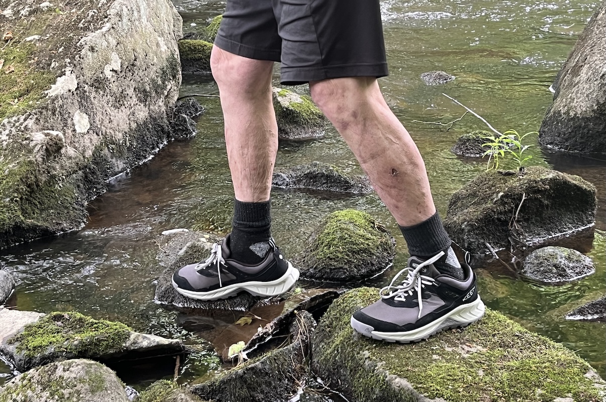 Keen waterproof hiking shoes with nubuck leather uppers crossing a shallow creek.