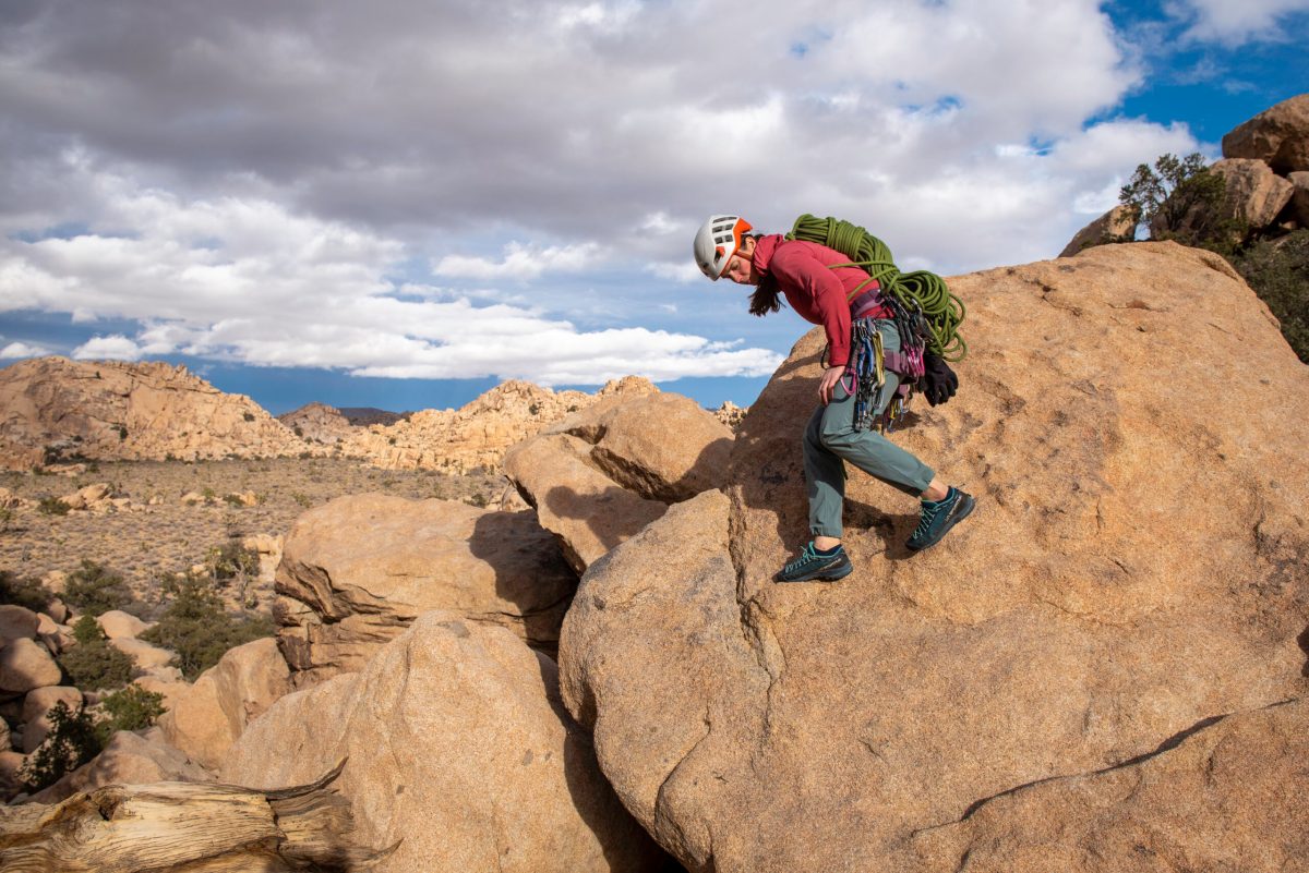 A wide variety of top-rated approach shoes lined up on a stone surface for comparison.