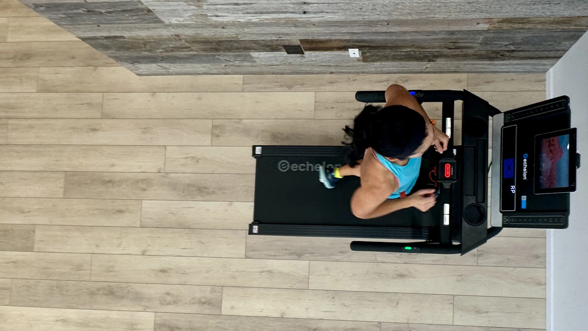 A top-down view of a treadmill with highlighted zones showing 2 feet of side clearance and significant rear clearance.