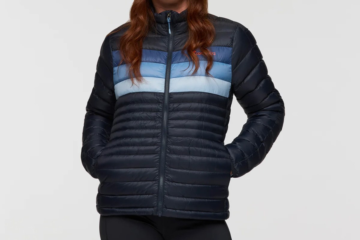 A colorful Cotopaxi Fuego down jacket with multi-colored horizontal baffles.