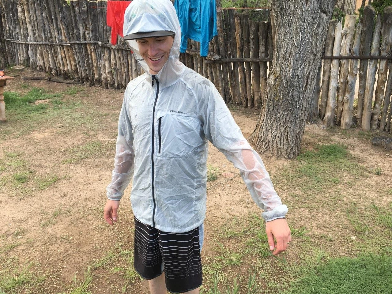 A windbreaker jacket being tested with a water hose to check DWR effectiveness.