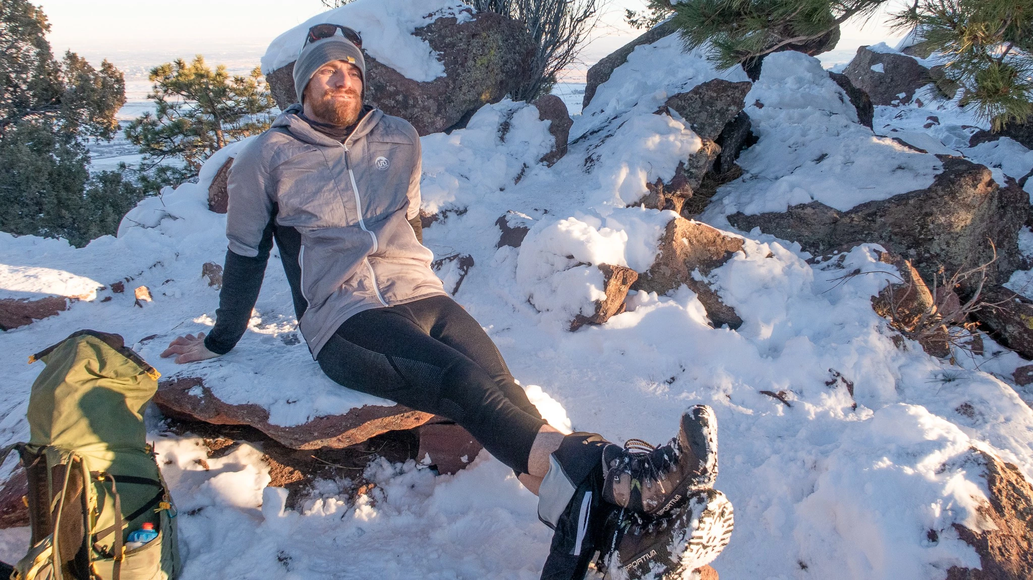 A hiker wearing 3/4 length merino wool bottoms on a snowy trail.