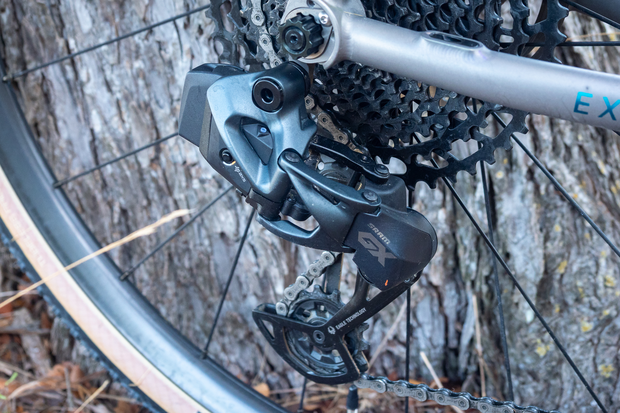 Close-up of a SRAM Apex XPLR AXS rear derailleur on a gravel bike.