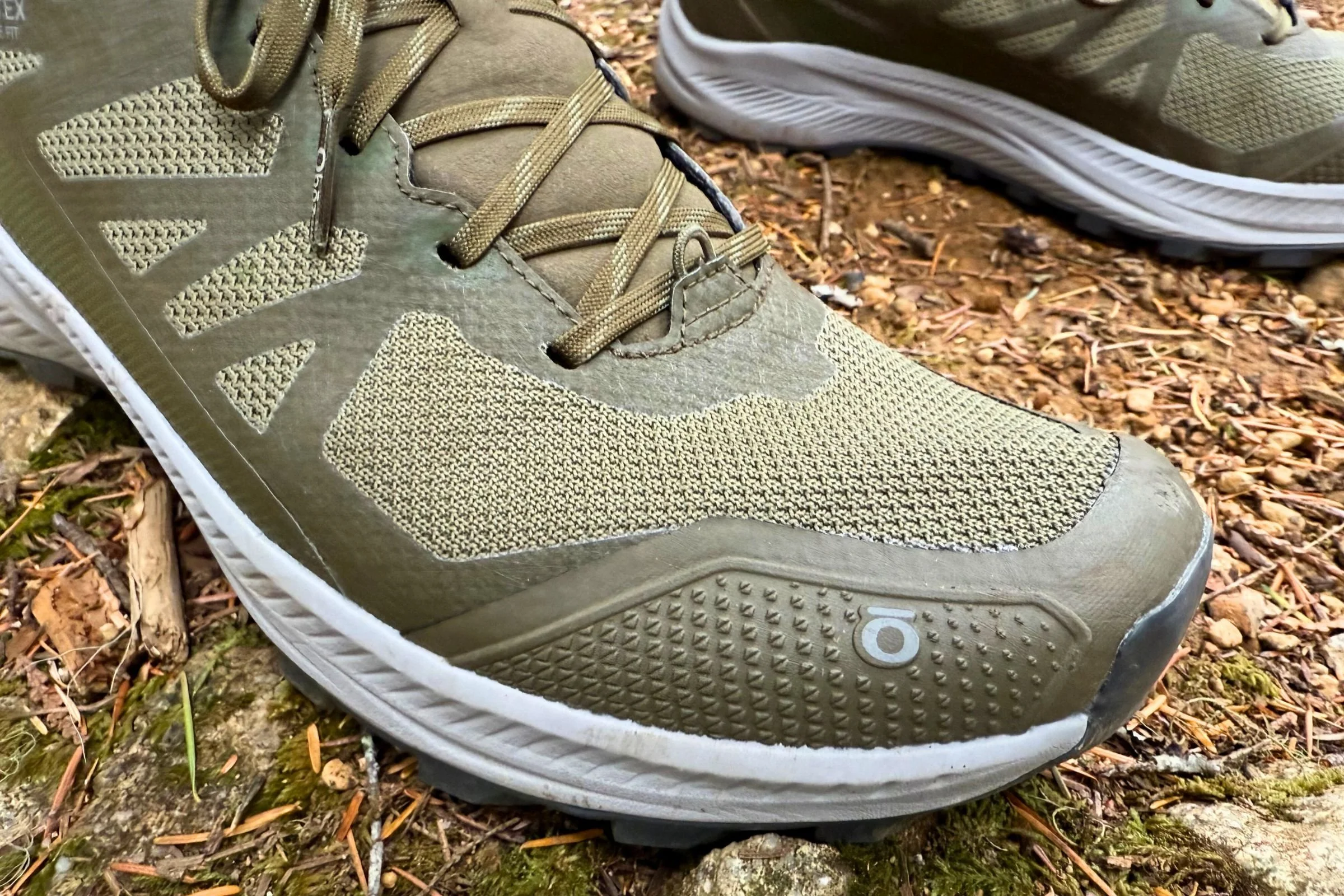 Close-up shot of the reinforced protective toe cap on a technical hiking shoe.