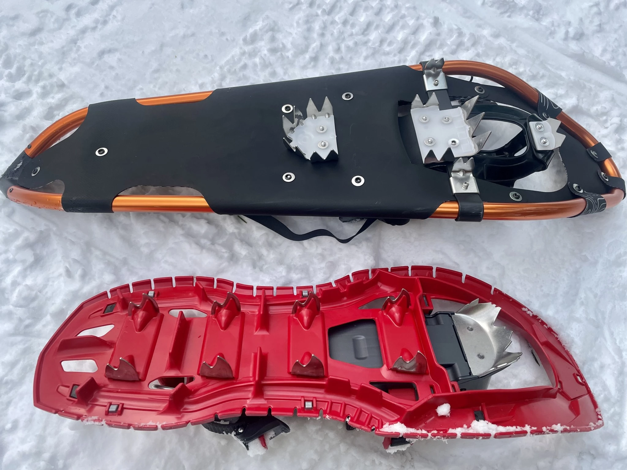 A side-by-side comparison of two snowshoe undersides showing different crampon and rail designs.