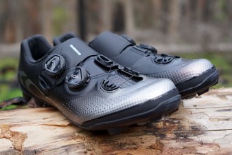 Side view of a blue and black Shimano XC7 cross-country mountain bike shoe.