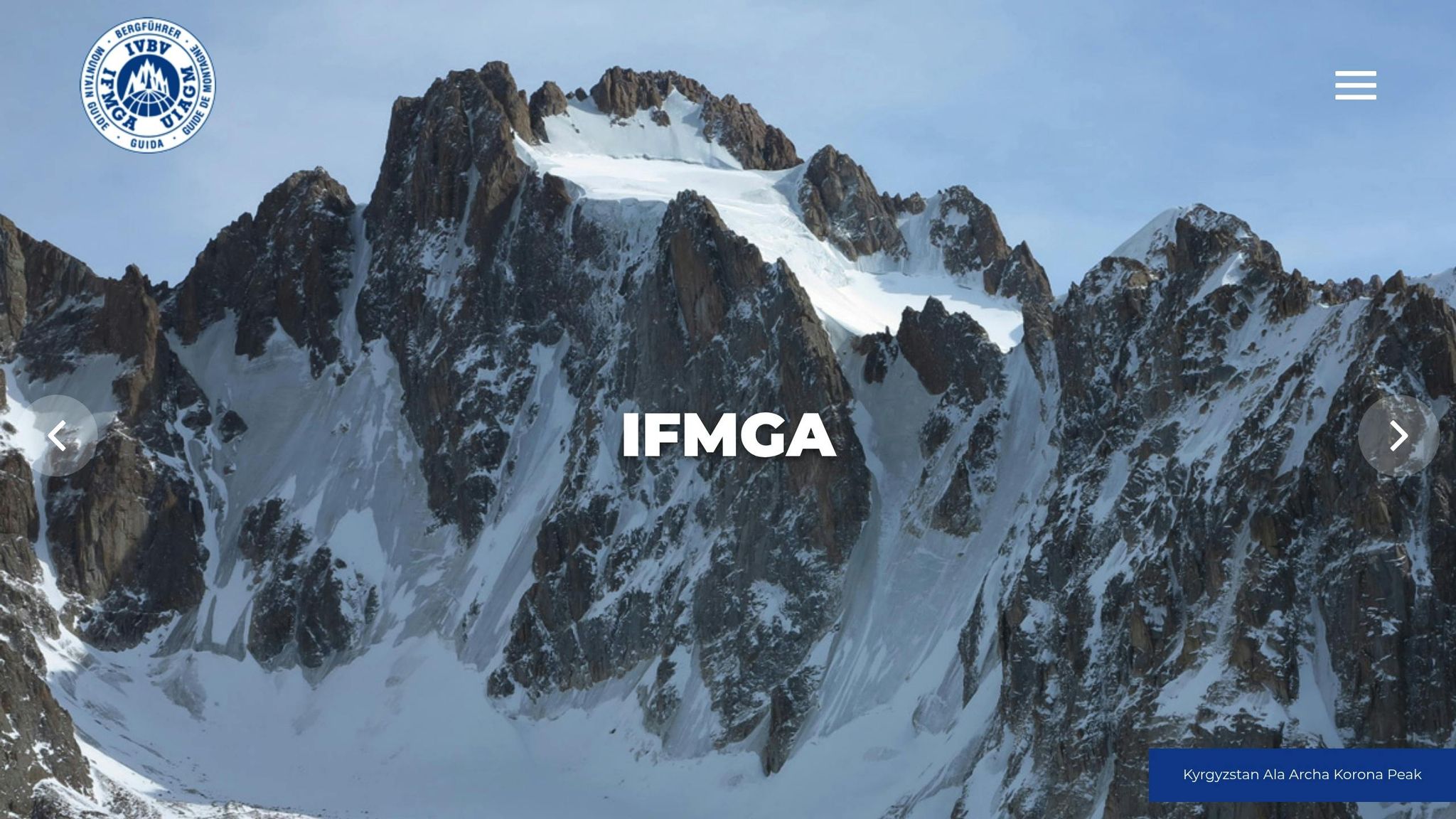 A mountain guide and a climber in winter gear talking while navigating a snowy slope.