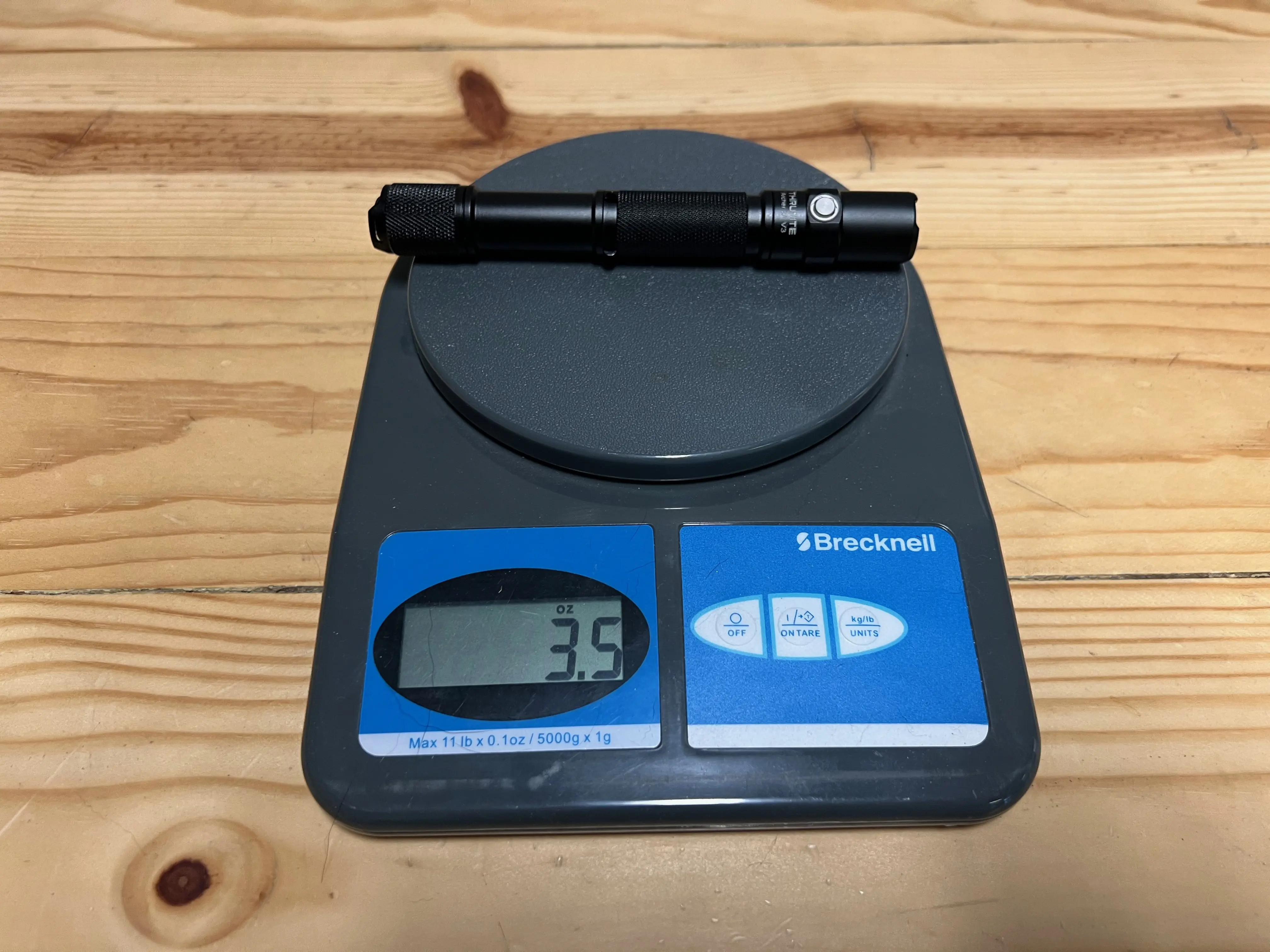 The ThruNite Archer being weighed on a digital scale with batteries included.