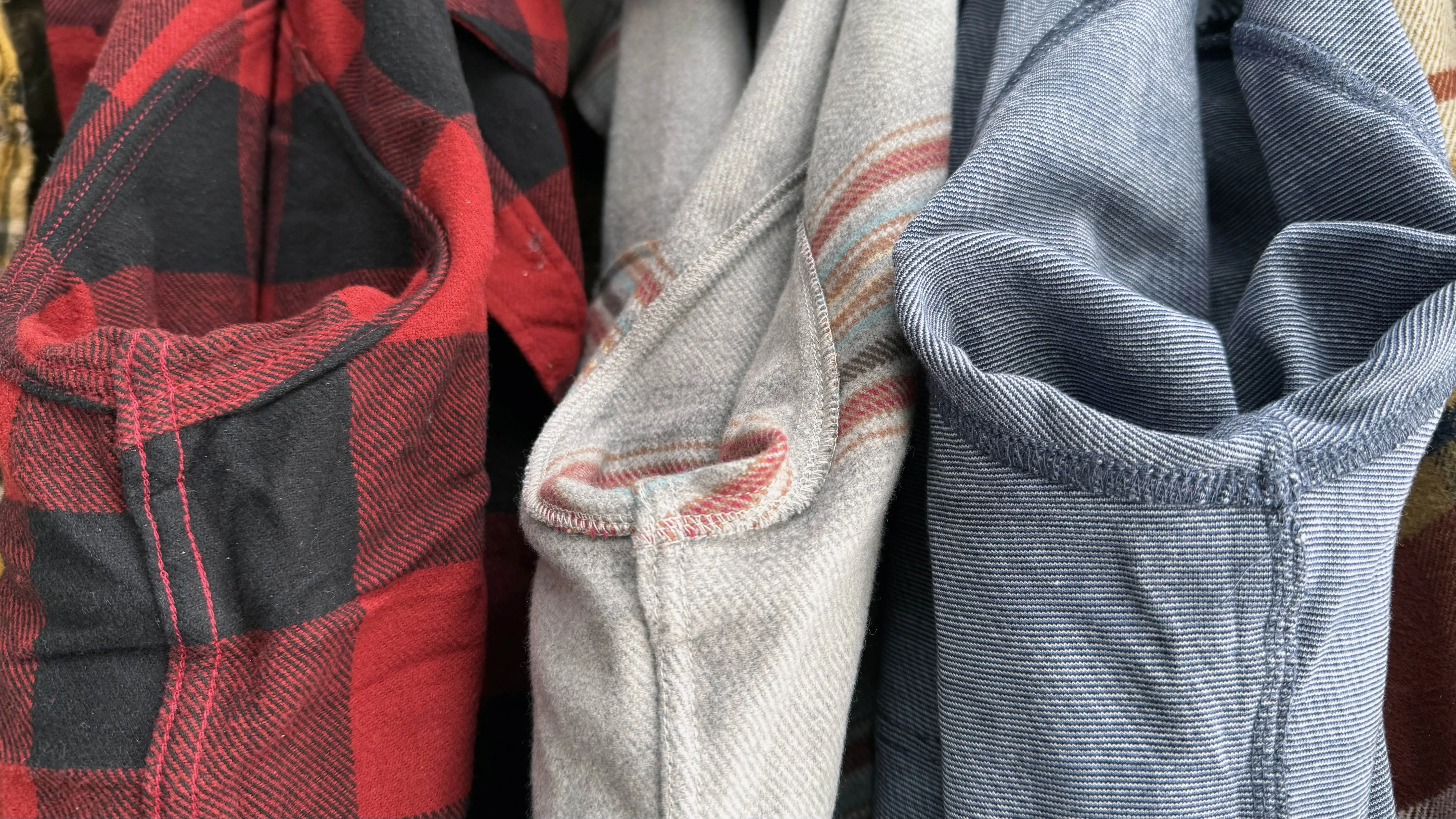 Comparison of different stitching techniques including flat-felled and overstitched seams across three shirts.