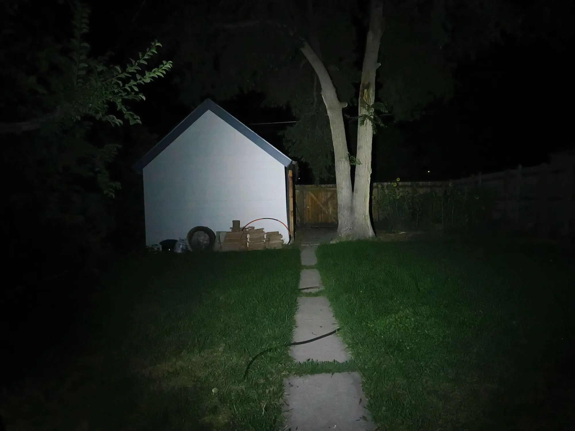 Nitecore EDC27 beam pattern casting a wide floodlight on a trail.