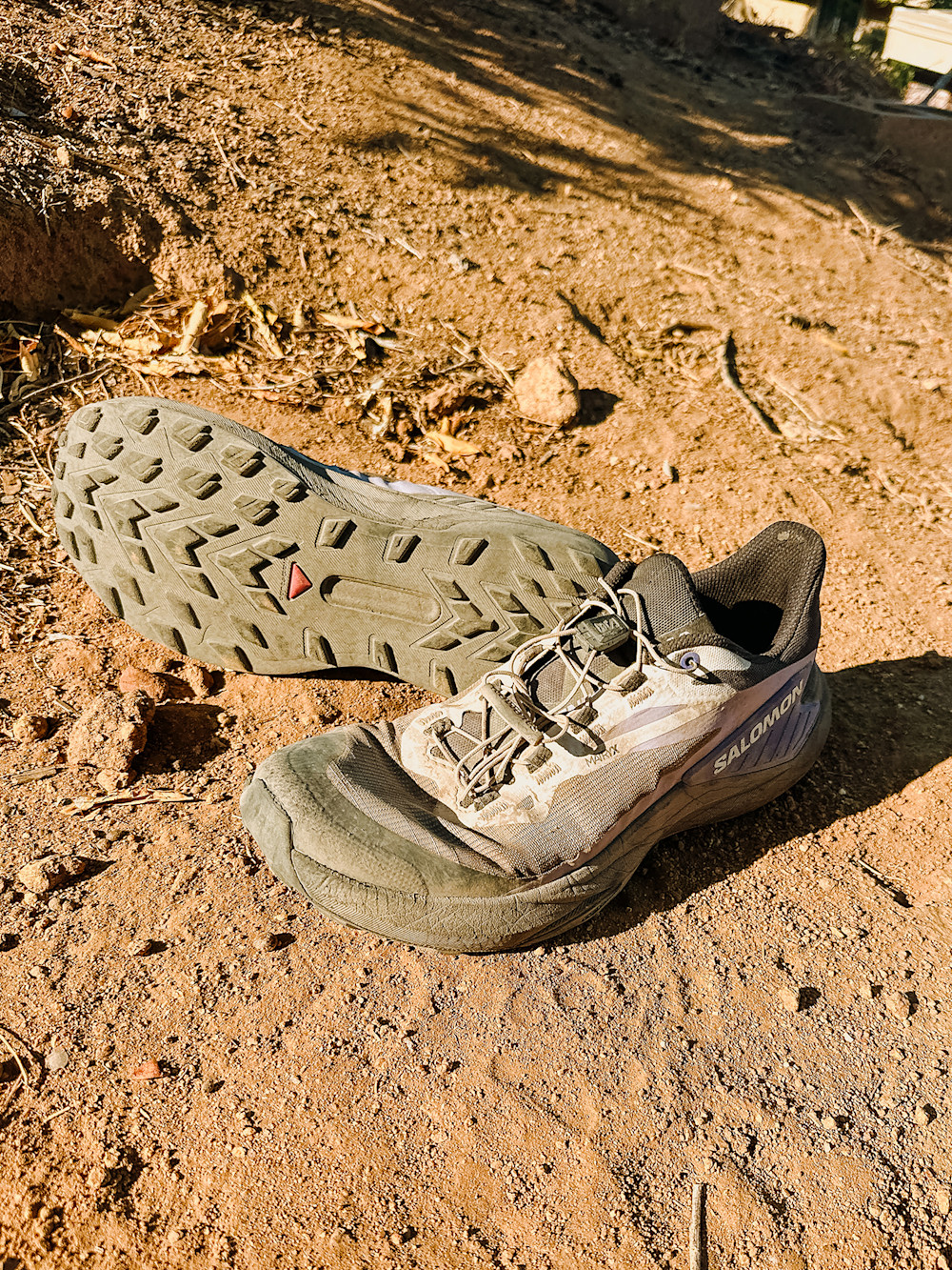 A thru-hiker wearing trail running shoes on a scenic mountain trail