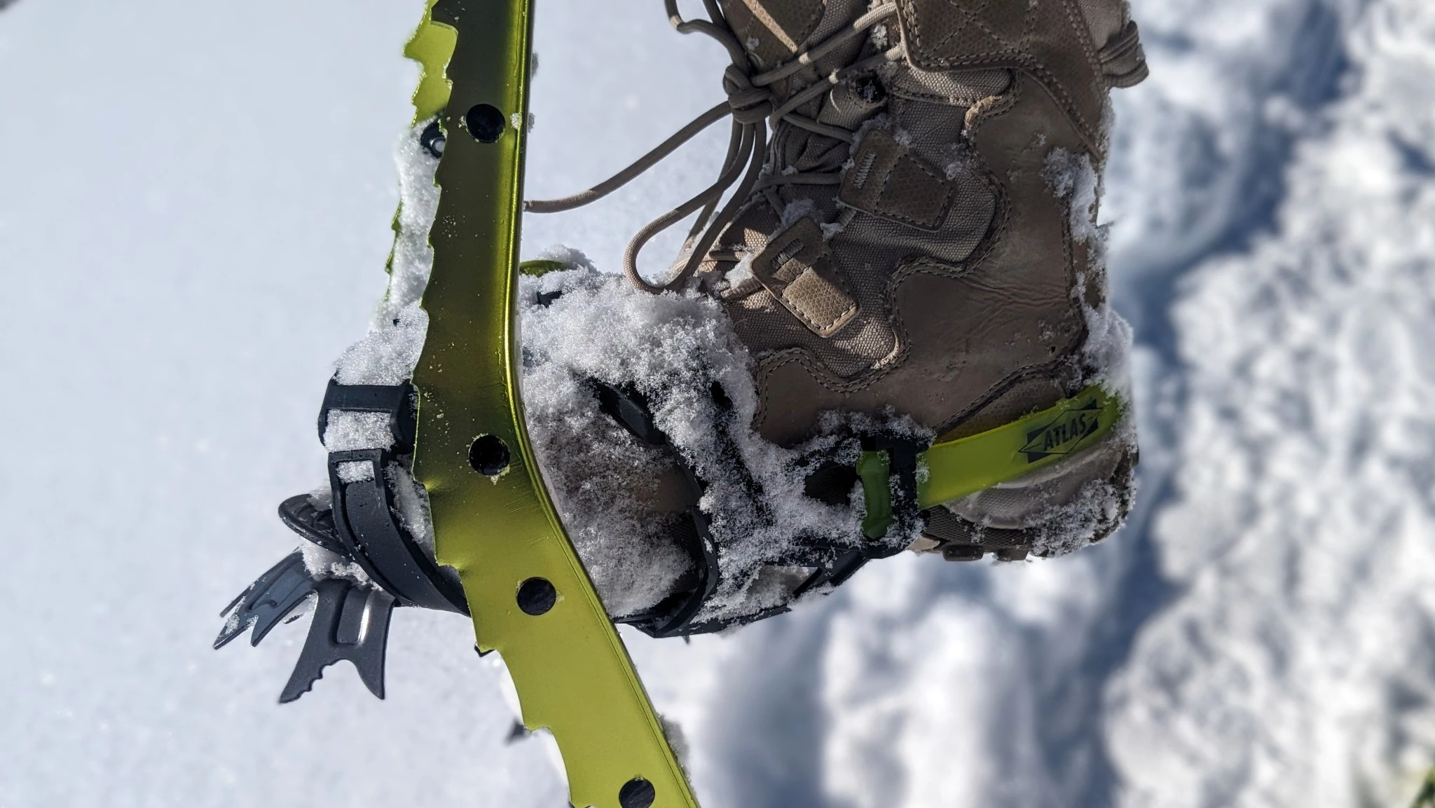 Detailed view of aggressive underfoot metal crampons for ice and technical climbing.