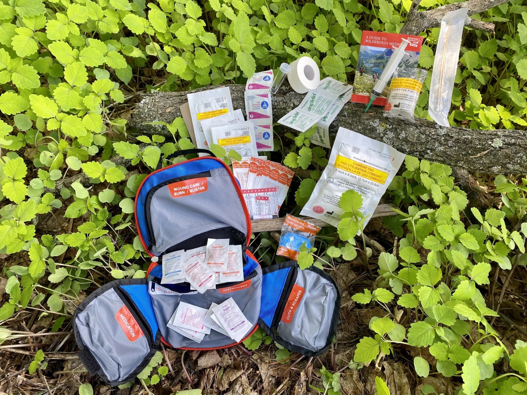 The internal view of an Adventure Medical Kit showing pockets labeled for specific medical needs like wound care and blisters.